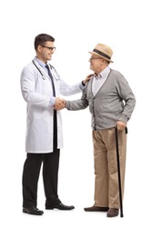 Full length profile shot of a doctor and a mature man shaking hands isolated on white background