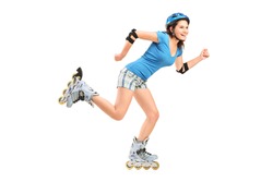 Full length portrait a smiling girl on rollers skating isolated on white background