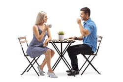 Young woman and a young man sitting at a coffee table isolated on white background