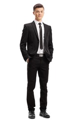 Full length portrait of a young male adult in an elegant suit posing with his hands in pocket isolated on white background