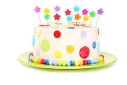 Colorful birthday cake with decorations, isolated on white background