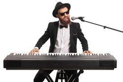 Man with sunglasses and a beard playing a digital piano and singing on a microphone isolated on white background