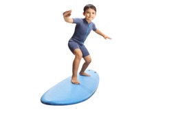 Full length portrait of a little boy surfing on a surfboard isolated on white background