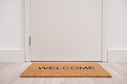 White door with a welcome mat