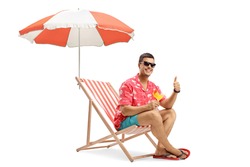 Man with sunglasses drinking cocktail and sitting under umbrella on a deckchair isolated on white background