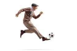 Active elderly man playing football isolated on white background