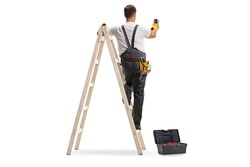 Full length rear view shot of a repairman on a ladder drilling with a machine into a wall isolated on white background