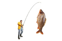 Fisherman in a yellow raincoat catching a big fish isolated on white background