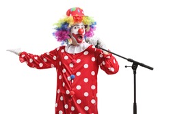 Full length portrait of a funny clown with a microphone isolated on white background