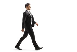 Full length profile shot of a businessman walking isolated on white background
