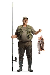 Full length portrait of a fisherman with a fishing rod and trouts on a hook isolated on white background