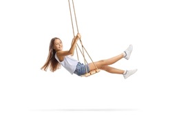 Beautiful girl with long hair swinging on a wooden swing isolated on white background