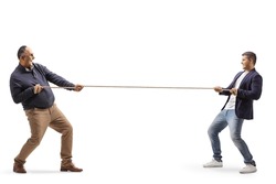 Full length profile shot of a a mature man and a young man pulling a rope isolated on white background