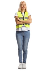Full length portrait of a young female wearing a reflective vest and posing with crossed arms isolated on white background