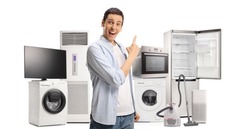 Happy young man pointing at home appliances isolated on white background