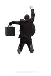 Rear view shot of a businessman with a briefcase jumping and celebrating success isolated on white background