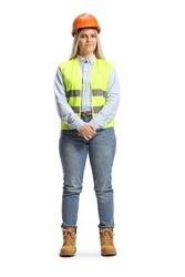 Full length portrait of a young female engineer wearing safety vest and hardhat isolated on white background