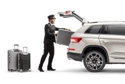 Bellboy putting suitcase in the trunk of a SUV isolated on white background