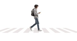 Full length profile shot of a young african american man using a phone and crossing street isolated on white background