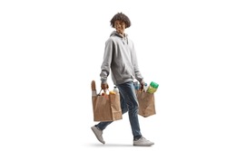 Full length shot of a young african american man carrying grocery bags walking and looking back isolated on white background