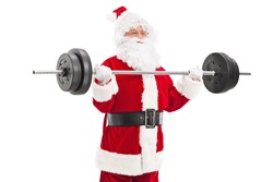 Santa exercising with a heavy barbell isolated on white background