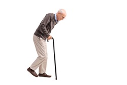 Studio shot of an exhausted old man walking with a cane isolated on white background