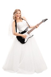 Full length portrait of a young blond bride playing electric guitar isolated on white background