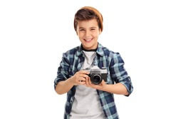 Cool little boy with a brown hat and checkered shirt holding a camera and smiling isolated on white background