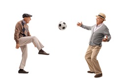 Two joyful senior passing a football and playing isolated on white background