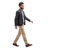 Full length profile shot of a young bearded man walking isolated on white background