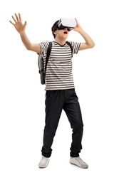 Full length portrait of a teenage student with a VR headset isolated on white backgroundh