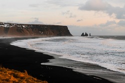 Iceland black beach Reynisfjara in Vik from Dyrholaey (Dyrhólaey) viewpoint. Coastline of black sand beach in Iceland.