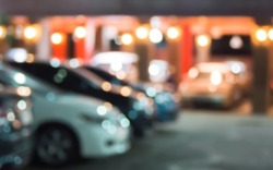 Abstract blurred car in hotel parking at night background.