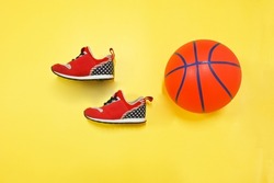 baby boy red navy stars  sneaker shoes  and basketball on yellow colourful background