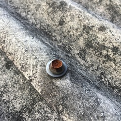 a rusty locking bolt on the corrugated roof of a house is found a lot in Indonesia