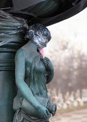 Statue of a woman with a face wrapped in cellophane as a symbolic depiction of violence against women