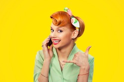 Call me. Closeup red head young woman pretty smiling pinup girl green button shirt holding phone showing call me sign hands gesture looking at you camera, retro vintage 50's hairstyle. Body language