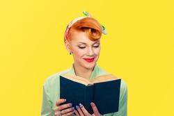 Girl with book. Closeup red head beautiful young woman pretty happy reading pinup girl green button shirt isolated yellow background wall. retro vintage 50's hairstyle love romance positive emotion