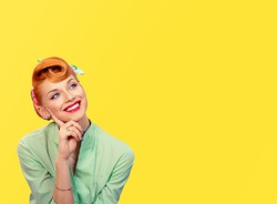 Daydreaming. Closeup red head young woman pretty smiling pinup girl green button shirt  dreaming about love career money looking up retro vintage 50's hairstyle. Body language Positive emotion feeling