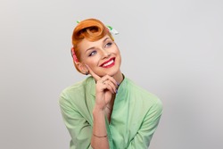 Daydreaming. Closeup red head young woman pretty smiling pinup girl green button shirt amazed pleasantly surprised thrilled dreaming about love, looking up retro vintage 50's hairstyle. Body language