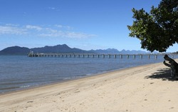 Jetty pier with the ocean and beach at Cardwell in North Queensland, Australia