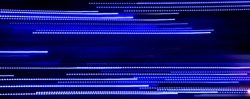 Abstract blue luminous horizontal lines background. High speed