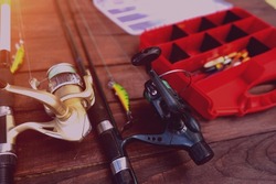 fishing rods and tackle on a wooden background