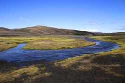 river under blue sky in the green plateau of iceland 