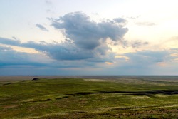 Scenic sunset with clouds in sky in steppe.