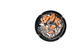 Dirty ceramic black ashtray full of cigarette butts Isolated on a white background view from above.