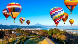 Landscape of Fuji Mountain and Shimizu Industrial Port with colorful hot air balloon over blue sky at Nihondaira, Shizuoka, Japan