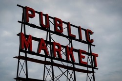 Public Market red sign with clouds in the background at Pike Place Market in Seattle Washington (1)