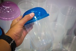 Plastic cup with curved lid.
