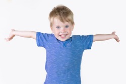 Portrait of cheerful kid boy showing something big with his hands, hands to the side - isolated over white background